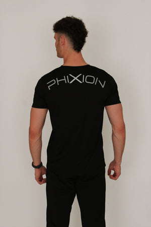 Back view of model wearing Phixion Active T-Shirt. Features bold curved Phixion branding across the upper back.