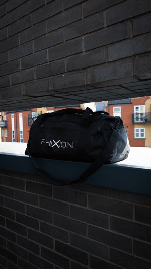 Phixion Gym Holdall placed in a lifestyle environment. Features side logo, structured design, and practical compartments.