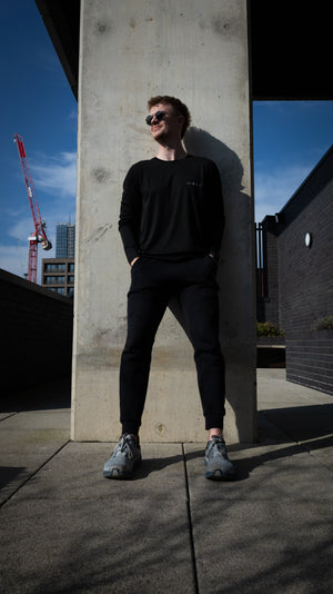 Phixion Active Long Sleeve T-Shirt styled in a lifestyle setting. Model showcasing versatility from workout to casual wear.